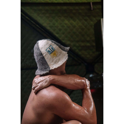 Man sweating inside KYFE portable sauna tent wearing wool sauna hat – wood-fired portable sauna heat and steam experience